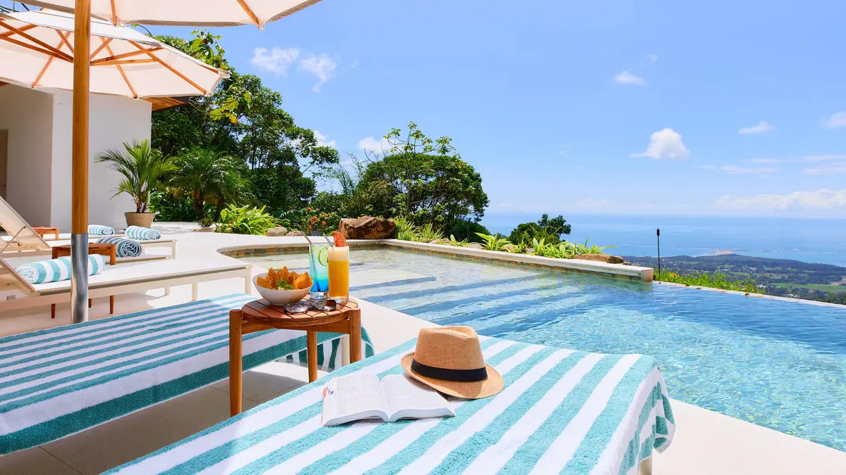 Infinity pool nestled into the rainforest hillside above the Pacific